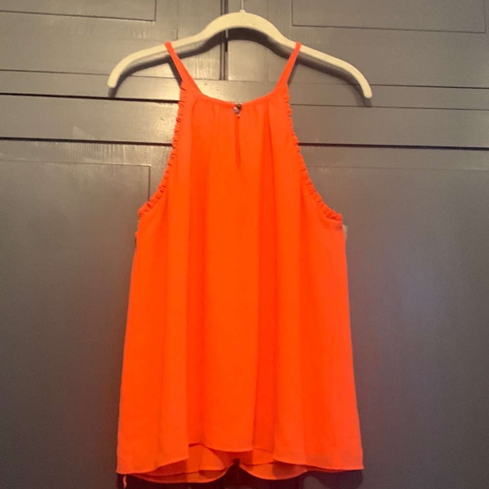 Naked Zebra coral summer top with cutaway arms and small ruffle details